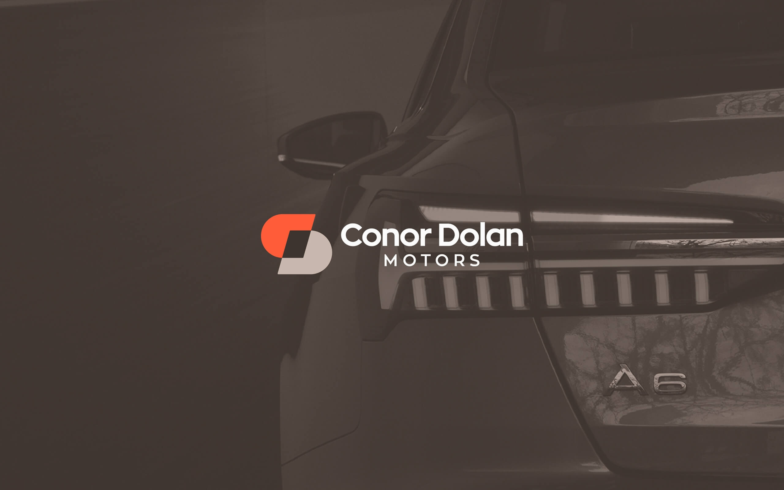 The Conor Dolan Motors' logo overlayed on a brown coloured Audi A6 background